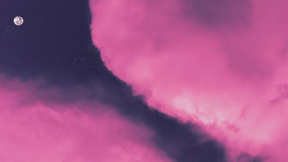 Soft pink clouds with the moon and stars
